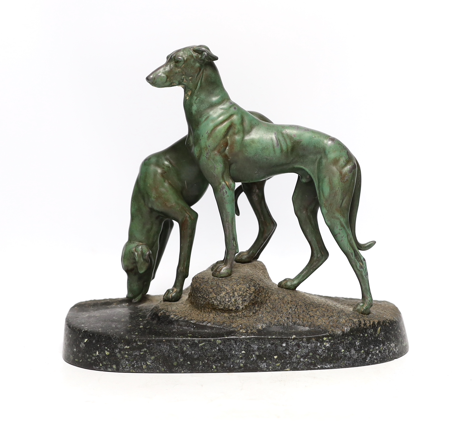 An early 20th century patinated spelter model of two hounds on a granite base, 29cm